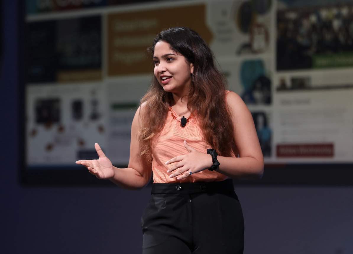 A Cisco Security intern gives a presentation on stage.