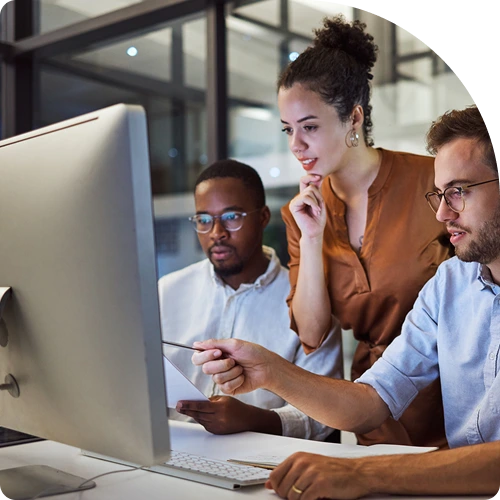 Group of data security experts observing authentication analytics on a large monitor.