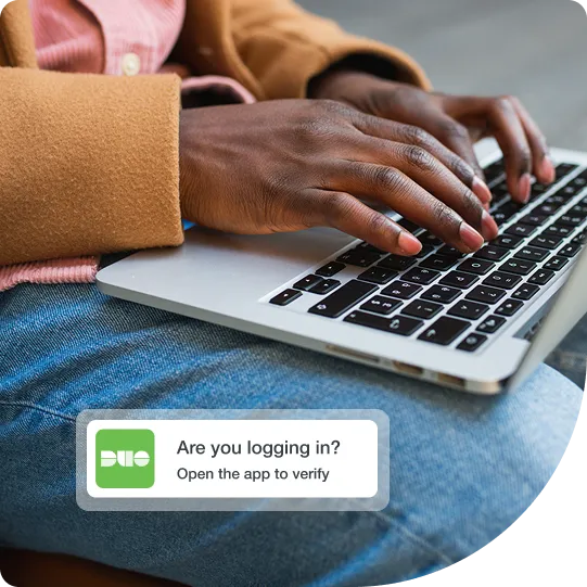 Trusted user working on a laptop using Duo multi-factor authentication with a simple prompt to gain secure access.