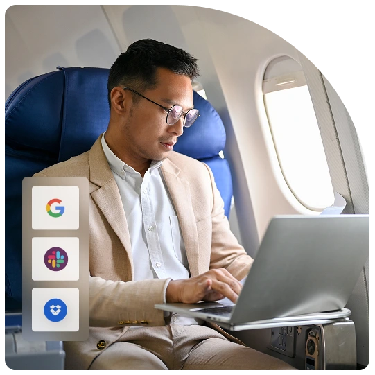 Man in a blazer works on a laptop on a plane, with Google, Slack, and Dropbox icons beside him