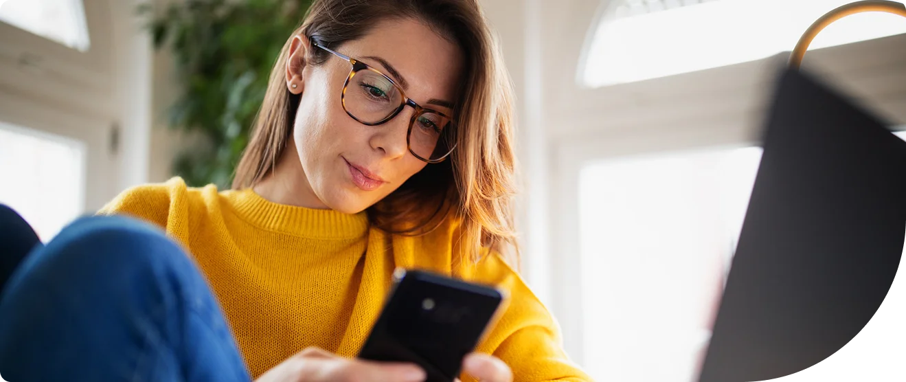 Woman looking at her smart phone, focused on the content that she is viewing on the screen