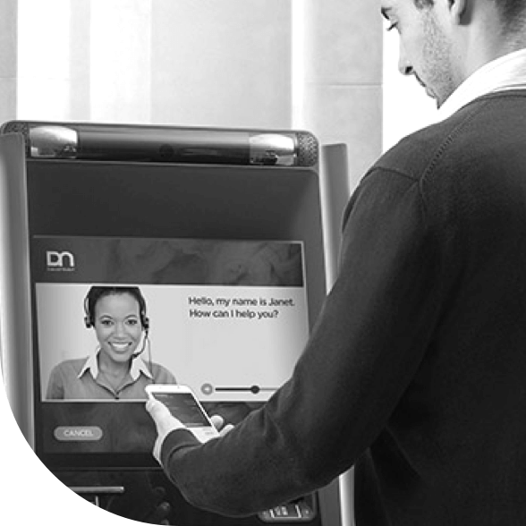 An image of a person standing in front of an automated teller machine