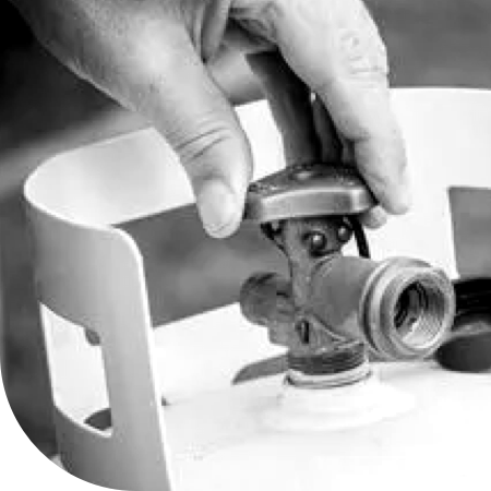 image of a gas tank with a hand turning the valve