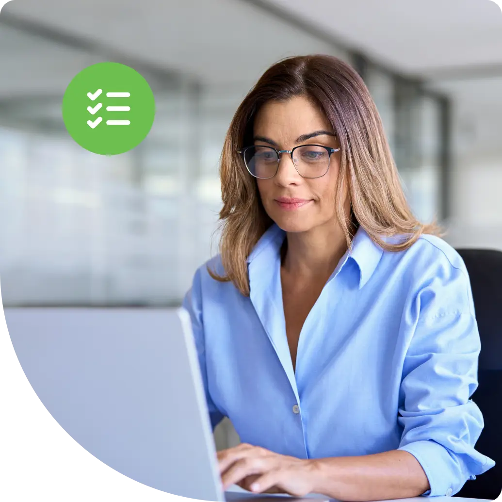 A woman securely accessing her laptop in a modern office, with a green access secured confirmation badge symbolizing verified privileged access