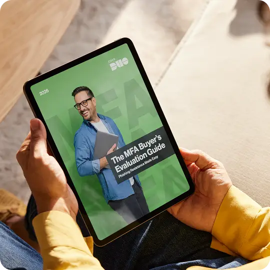 Duo's eBook for the Multi-factor Authentication Buyer's Evaluation Guide being held by a person in an office.