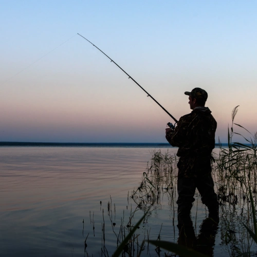 Person fishing at sunset representing no phishing.