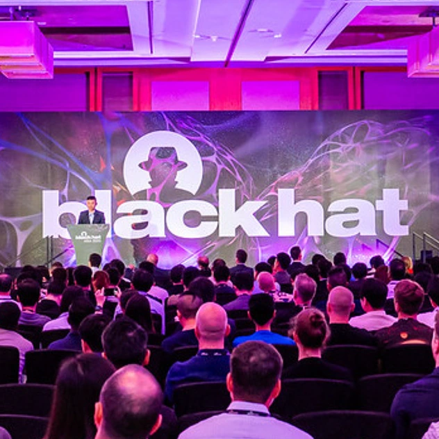 A photo of a black hat employee presenting at a conference
