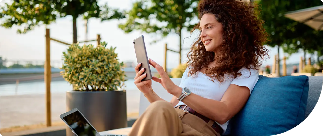 A professional uses a tablet to securely access a cloud application, representing risk-based authentication protecting remote workforce access