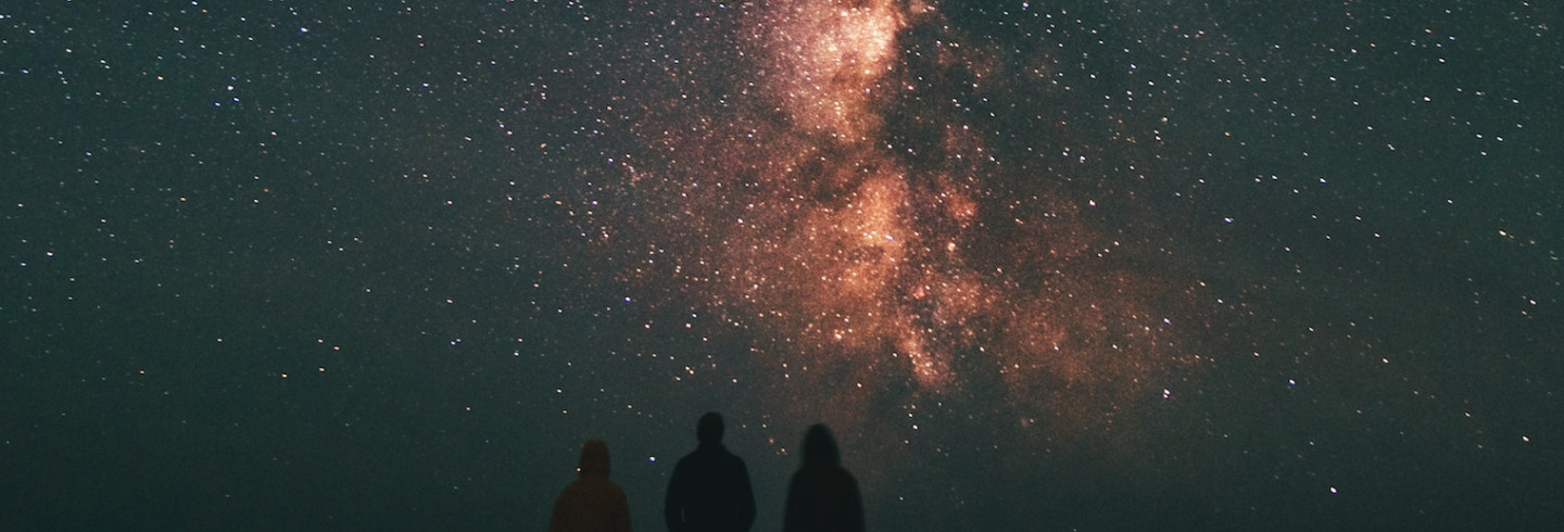 Stargazers look up into a beautiful night sky, thinking about perimeterless security.