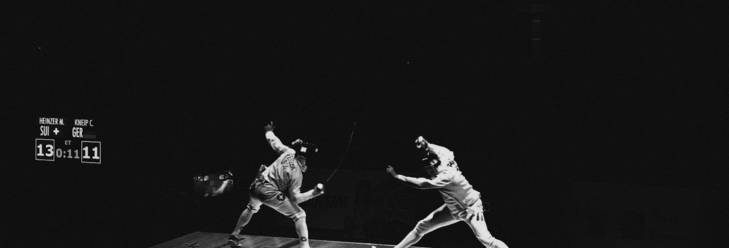 Two fencers tangle in a match; the score is 13 to 11 with 11 seconds left.