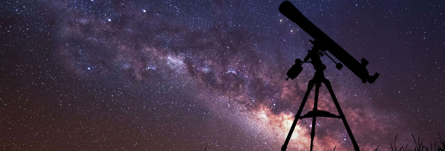 A telescope points into a galaxy-filled night sky, representing perimeterless data security.